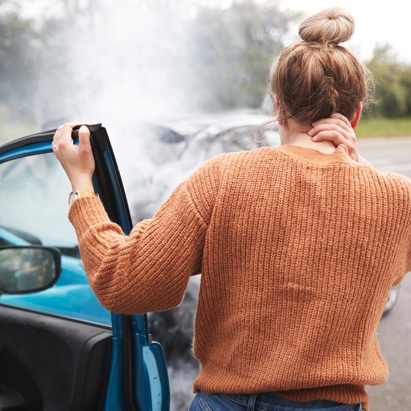 woman holding neck after car accident